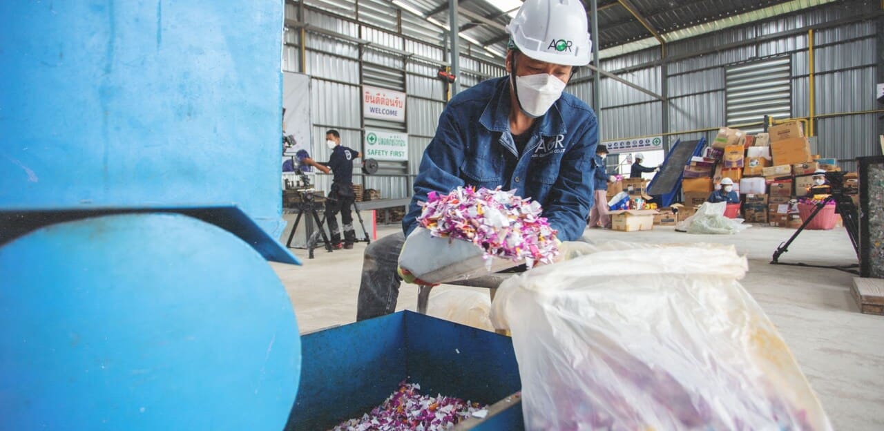 a worker recycling the plastic waste in a factory