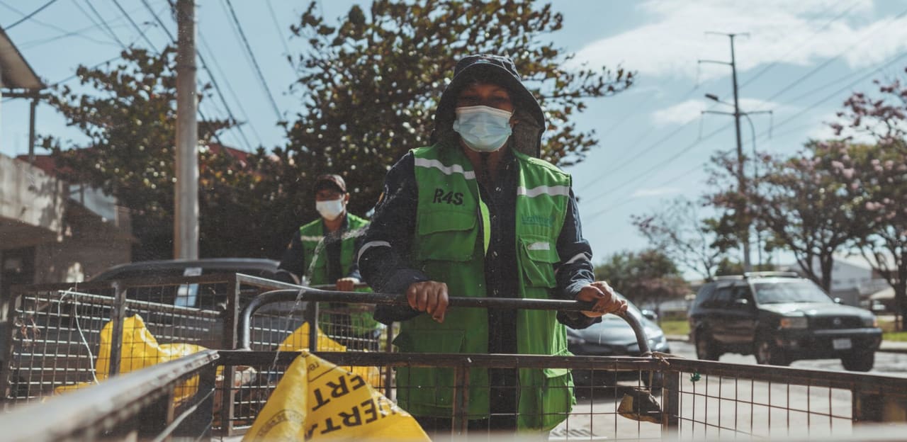 R4S group's workers with green vests carrying plastic waste bags